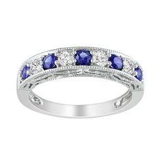 a white gold ring with blue and white stones on the sides, surrounded by diamonds