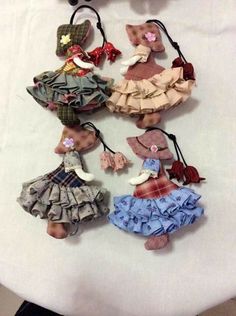 several small dolls are hanging on a table