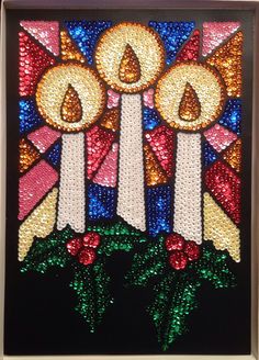 a stained glass window with three candles on it