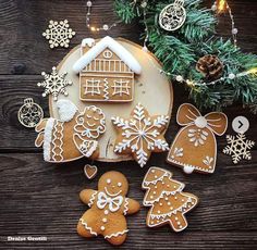 gingerbreads and cookies are arranged on a plate next to a christmas ornament