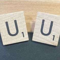 two wooden blocks with the letters u and i on them