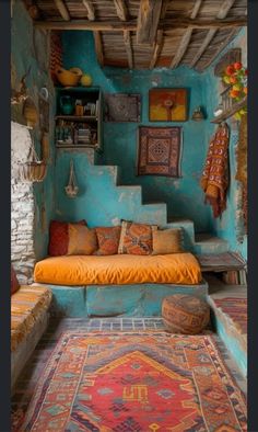 a room with blue walls and rugs on the floor, stairs leading up to it