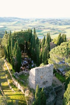 an aerial view of a castle surrounded by trees and greenery in the middle of nowhere