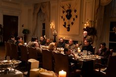 a group of people sitting around a dinner table