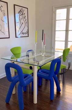 a glass table with blue chairs around it