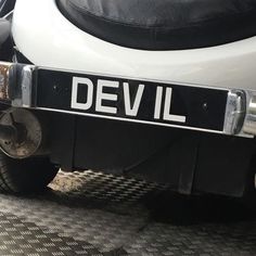 the back end of a white motorcycle with black and silver trim