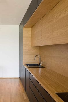 an empty kitchen with wooden cabinets and counter tops