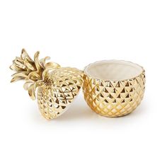 two gold pineapples sitting next to each other