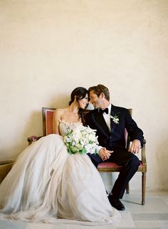 a man and woman are sitting on a bench