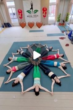 a group of people laying on top of yoga mats