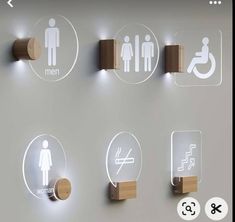 a bathroom wall with several signs and lights on the walls, including men's restrooms