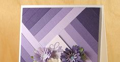 a close up of a greeting card with flowers on the front and purple stripes in the back