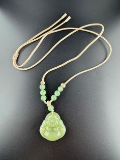 This exquisite Hetian Jade Buddha Pendant Necklace is a stunning piece of minimalist gemstone jewelry, perfect for those who appreciate the beauty of simplicity. Hand-carved with meticulous attention to detail, this pendant showcases the serene and calming presence of the Buddha, making it a meaningful addition to any jewelry collection. The pendant measures approximately 1.18 inches in height, 1.18 inches in width, and 0.38 inches in thickness, making it an ideal size for everyday wear. Its ele Buddha Pendant Necklace, Jade Buddha, Hetian Jade, Buddha Pendant, Meaningful Gifts, Good Luck, Elegant Design, Gemstone Jewelry, Jewelry Necklace Pendant