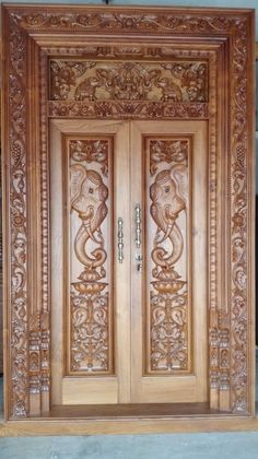 an ornate wooden door with carvings on it