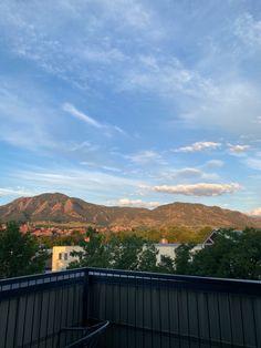 the mountains are in the distance as seen from an apartment balcony