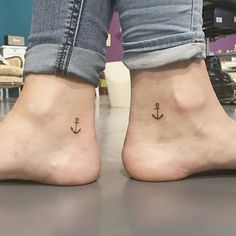 two people with small tattoos on their feet, one has an anchor and the other has a heart