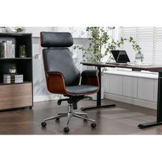 an office chair sitting in front of a desk with bookshelf and computer monitor