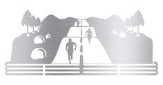 the silhouette of a man running on a road with mountains and trees in the background