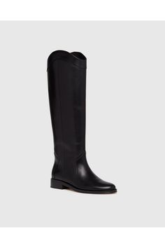 Find PAIGE Raina Boot on Editorialist. Raina is our take on the classic riding boot. Crafted from a super durable yet luxuriously soft black leather, this timeless straight shaft tall boot is designed with a curved topline that dips at the front and back for a flattering look, western-inspired pattern and stitch detailing, an extended leather welt with tonal stitch details, and a black leather stacked 20mm heel for a slight amount of lift. The classic menswear-inspired details on the outsole inc Classic Calf Leather Knee-high Boots With Leather Sole, Classic Knee-high Boots With Calf Leather, Elegant Wide Calf Knee-high Riding Boots, Elegant Wide Calf Knee-high Boots For Riding, Classic Wide Calf Knee-high Boots In Calf Leather, Classic Knee-high Boots In Calf Leather, Classic Calf Leather Wide Calf Knee-high Boots, Elegant Wide Calf Riding Boots, Classic Calf Leather Knee-high Boots For Business