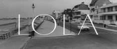 black and white photo of the word loja written in front of an empty street