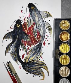 an artist's watercolor painting with gold and black fish in it, next to some paintbrushes