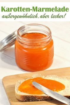 there is a sandwich on a cutting board with a knife next to it and a jar of ketchup