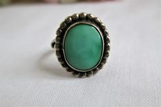 "This is breathtaking beautiful Vintage Navajo Sterling Silver Turquoise Ring Size 4 1/2 STUNNING! Vintage Jewelry . The colors, and detail is just fabulous on This Lovely piece, and it is in wonderful condition with original patina. The stone has an imperfect mark, and was made that way. Please study the photos for they are the best description. It is not marked sterling, but I took it to a jewelers to confirm it was sterling. Being Sterling, you could have it sized at your local jewelers if ne Vintage Green Turquoise Ring, Vintage Green Turquoise Cabochon Ring, Adjustable Green Emerald Bohemian Ring, Adjustable Green Bohemian Emerald Ring, Adjustable Bohemian Green Emerald Ring, Vintage Adjustable Green Turquoise Ring, Green Oval Turquoise Bohemian Ring, Bohemian Green Oval Turquoise Ring, Nickel-free Green Bohemian Rings