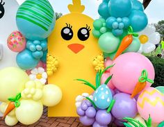 an assortment of balloons and decorations for a baby's first birthday or easter party