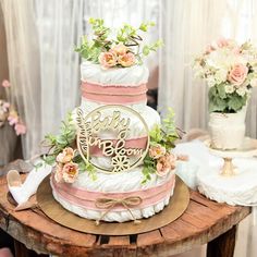 a wedding cake sitting on top of a wooden table