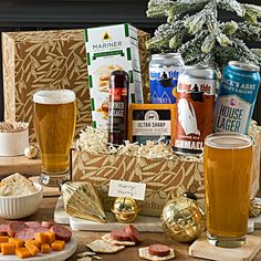 an assortment of beer and snacks on a table