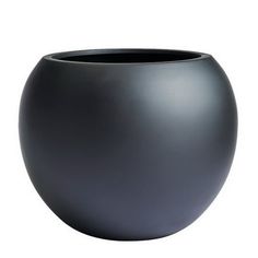 a black vase sitting on top of a white table