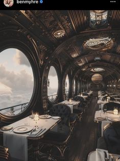 the inside of a train car with tables and chairs on each side, looking out onto the ocean