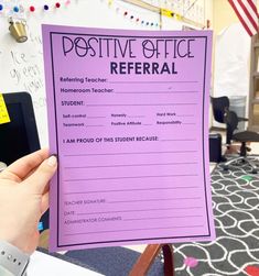 a person holding up a purple piece of paper with the words positive office refer written on it