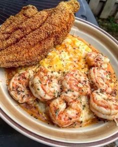 the meal is prepared and ready to be eaten on the plate with shrimp, mashed potatoes, and bread