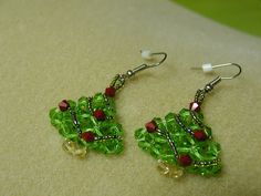 These dangling  earrings are hand made with green and red bicone crystals and garland done with lime rainbow color seed beads and hung on a silver  fishhook surgical steel wire earrings. Christmas Green Dangling Beads Earrings, Christmas Green Earrings With Dangling Beads, Nickel-free Green Beaded Earrings For Parties, Handmade Green Crystal Earrings With Round Beads, Green Wire Wrapped Crystal Earrings As Gift, Green Wire Wrapped Crystal Earrings For Gift, Green Czech Glass Beaded Earrings, Wire Wrapped, Green Wire Wrapped Czech Glass Beaded Earrings, Green Wire Wrapped Beaded Earrings For Gift