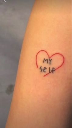 a small heart tattoo with the word my self written on it's left arm