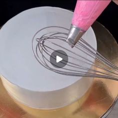 a video demonstrating how to make a cake with fondant icing and whisk