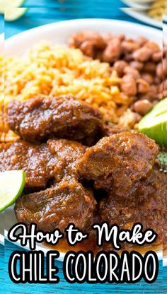 a white plate topped with meat and rice next to lime wedges on a blue table