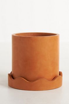 a large brown pot sitting on top of a white table