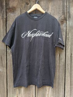 A classic and rare vintage skate tee. Features nicely distressed black cotton, the 'Neighborhood' logo front & center, small Stussy graphic on the left sleeve, a comfy oversize fit, and lots of retro streetwear chic. A cool collectible and great gift. Brand : STUSSY Neighborhood 'Boneyards' 100% cotton Made in Mexico of US components Labeled size XL (I'd say Men's XL, Ladies' 2XL) All measurements taken with garment lying flat, double where necessary 23 inches shoulder seam to shoulder seam 23.5 Washed Black Graffiti Print Top For Streetwear, Washed Black Graffiti Print T-shirt For Streetwear, Band Merch T-shirt In Washed Black For Streetwear, Graffiti Print T-shirt For Skateboarding, Washed Black Graffiti Print Grunge T-shirt, Black Logo Print Top For Skateboarding, Washed Black Grunge T-shirt With Graffiti Print, Grunge Washed Black T-shirt With Graffiti Print, Black Tops With Logo Print For Skateboarding