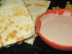 three quesadillas and a bowl of dip