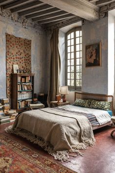 a bedroom with a bed, bookshelf and rugs on the floor in front of a window