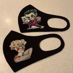 two black masks with cartoon images on them