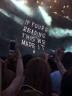 someone holding up their cell phones in front of an audience with the words if you're reading this we made it