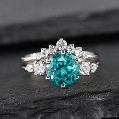 Gemstone can be replaced with other birthstone, if you would prefer a custom ring, please contact us. ★Description *Center stone: 8mm Round Cut Lab Paraiba Tourmaline *Accent stone: 0.18 Ct CZ or Moissanite(10K/14K gold only) * Material: Sterling Silver with White/Yellow/Rose Gold Plated or Solid 10K 14k Gold( White/Rose/Yellow gold) *Band Width(Bottom): 1.6mm Wedding Band: 0.21 Carat Moissanite /(solid gold only) or CZ ★Procedure information Please select the material and ring size from the dro Sapphire Ring For Wedding With Round Cut, Tourmaline Ring With Center Stone For Wedding, Tourmaline Emerald Wedding Ring With Prong Setting, Wedding Tourmaline Emerald Ring With Prong Setting, Tourmaline Wedding Rings For May Birthstone, Emerald Ring With Round Stone For Wedding, Emerald Birthstone Ring For Wedding With Round Stone, Wedding Emerald Ring With Tourmaline Accent Stones, Emerald Wedding Ring With Round Stone