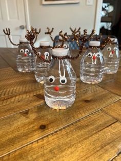 four water bottles with reindeer noses on them