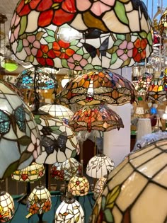 many different colored lamps hanging from the ceiling