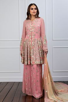 Pink peplum kurta embroidered with floral motifs in patra and thread work. Paired with embroidered sharara.
Components:2
Pattern:Embroidered
Type of Work:Patra, Thread work, Floral motifs
Neckline:Round neck
Sleeve Length:Full sleeves
Fabric:Georgette
Color:Pink
Other Details:
Embroidered motifs
Gathered detailing
Front button opening
Note: The dupatta worn by the model is not for sale.
Occasion:Sangeet - Aza Fashions Pink Embroidered Fabric With Dabka Work For Reception, Embroidered Pink Fabric With Dabka Work For Reception, Unstitched Embroidered Sharara For Reception, Unstitched Sharara With Resham Embroidery For Reception, Embroidered Chinon Sharara For Reception, Wedding Semi-stitched Palazzo Set With Floral Embroidery, Semi-stitched Embroidered Sharara For Reception, Traditional Raw Silk Sharara With Floral Embroidery, Bollywood Style Sharara With Floral Embroidery In Chinon