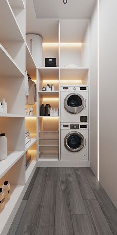 a washer and dryer in a small room with shelves on the wall behind them