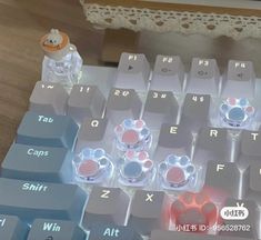 a computer keyboard sitting on top of a wooden table